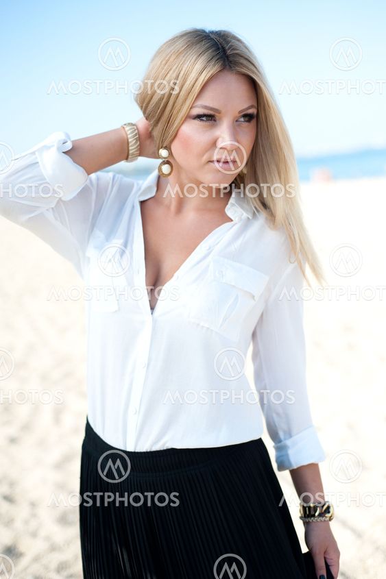The beautiful young girl plays with hair