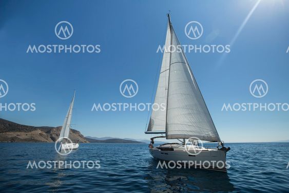 Two luxury yachts sailing on the sea.