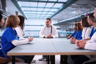 diverse team of professionals giving a medical...