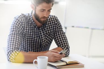 Phone, notebook and reading with business man in office...
