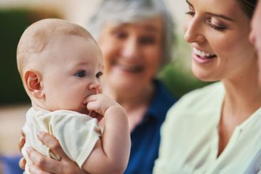 Mother, baby and grandparents joy in nature, support and...