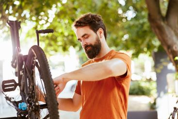 Bicycle maintanence by caucasian man