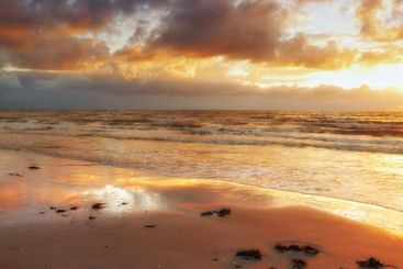 Clouds, nature and sky with sunset on beach for holiday,...