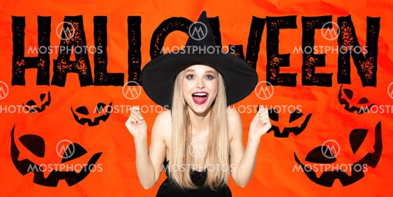 Young woman in hat as a witch on scary red background