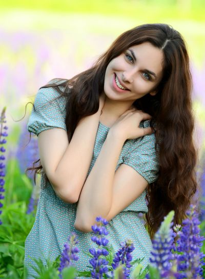 The beautiful woman in the field with lupin