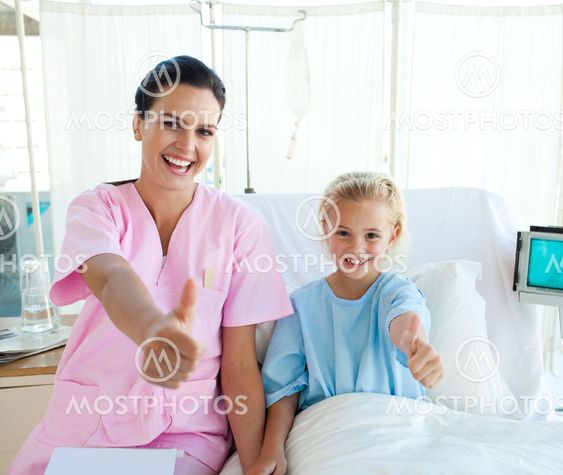 Female doctor and her little patient with thumbs up