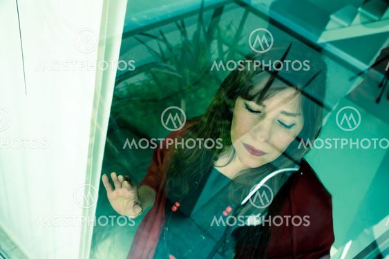 Mature woman looking out the window