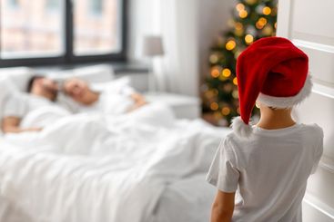 boy entering parent's bedroom in christmas morning