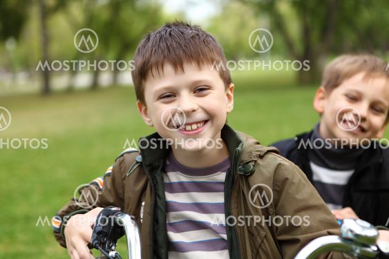 Boy on a bicycle in the green park