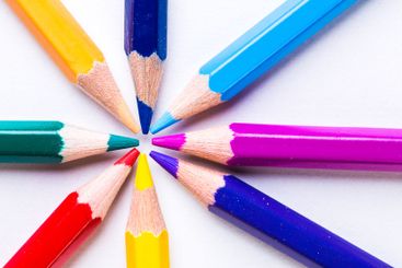 Colorful arrangement of sharpened pencils radiating from...
