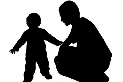 Affectionate father looking at his baby walking