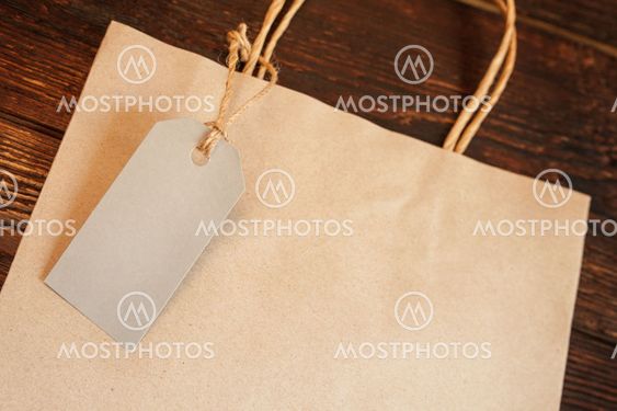 Mockup craft paper shopping bag with tag on vintage...