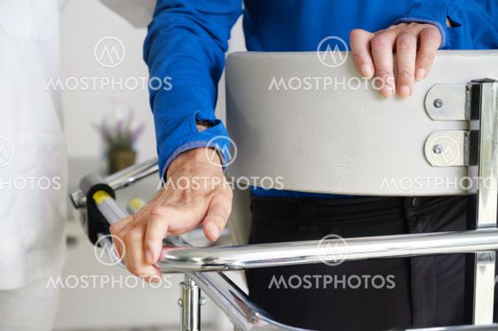 Physiotherapist assisting a patient with Amyotrophic...