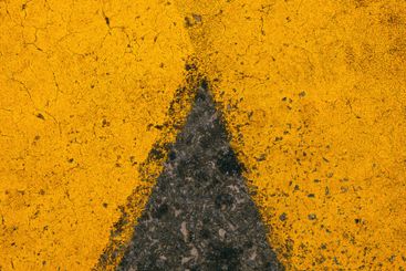 Yellow paint road marking on asphalt highway surface,...