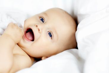 Baby, boy and happy with sheet, home and playful with...