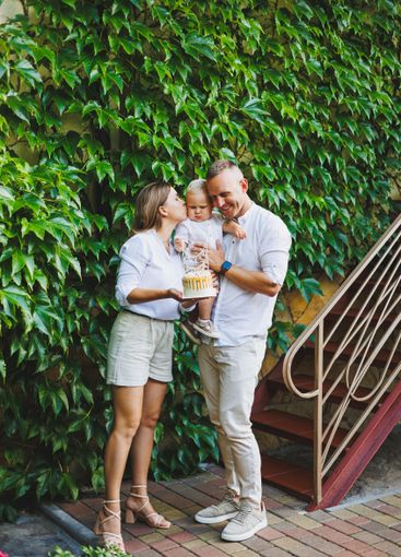 Mom and dad in nature with their one-year-old son...