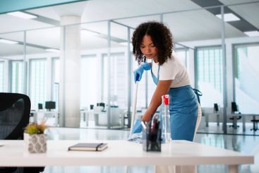 Portrait Of Happy Female Janitor Cleaning Floor