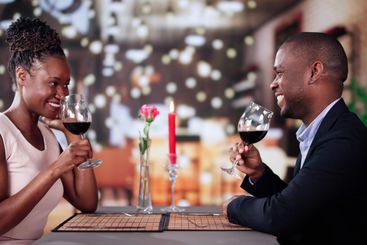 Portrait Of Romantic Couple Toasting Red Wine