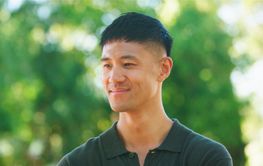 Young Man Smiling in Nature During Daytime