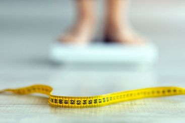 Measuring tape on floor and blurred view of millennial...