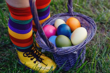 Close-up of legs of toddler girl with colorful stockings...