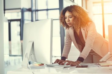 Reading, computer and typing with business woman in...