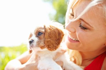 Woman, smile and outdoor with dog for love, pet care and...