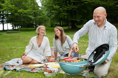 Friends Having Meal At An Outdoor Picnic