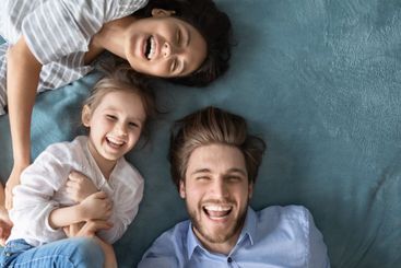 Portrait of overjoyed parents play with little daughter