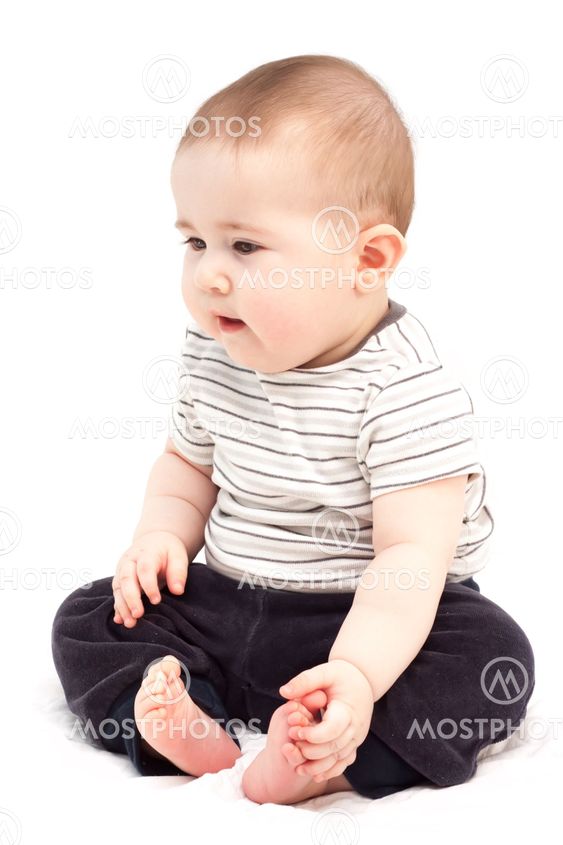Thoughtful child sits and looks aside