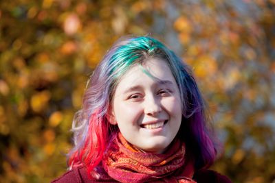 happy young woman with multicoloured streaks hair