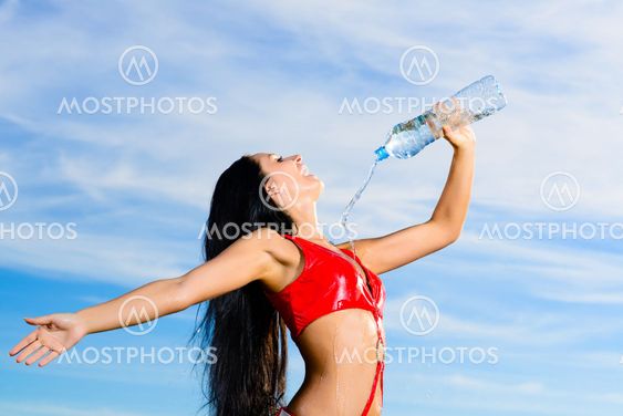 sport girl in red uniform with a bottle of water