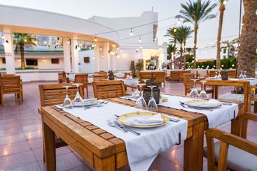Romantic outdoor dining setup in a warm evening...