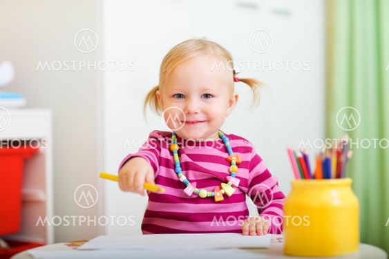 Playful little girl drawing