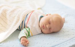 Little baby on white bed