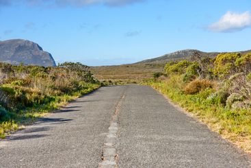 Road, mountain and nature with blue sky for travel,...