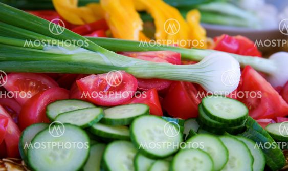 Fresh vegetables prepared for salad. Shallow depth of field, focus on onion