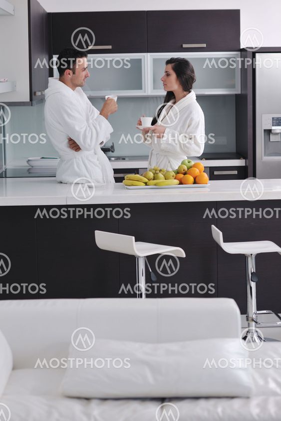 young couple have fun in modern kitchen