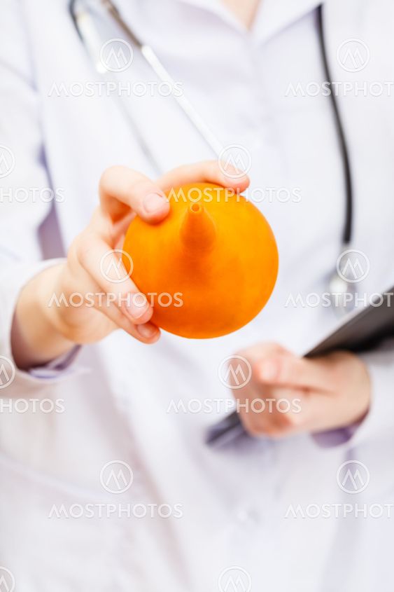 nurse hold yellow rubber enema