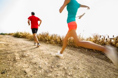 Young woman on her evening jog along the seacoast (motion...