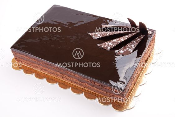 Chocolate glossy dark Cake on white stuffed with nuts
