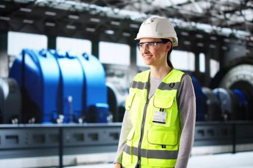 Portrait of smiling young woman working as power plant