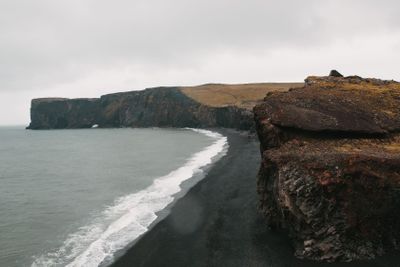 majestic icelandic seacoast with black sand and cliffs,...