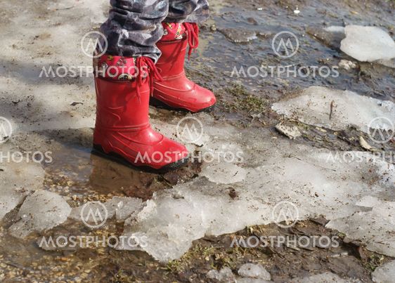 child's legs in boots