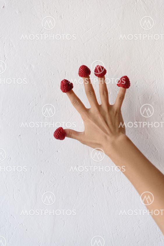 raspberries on female hand