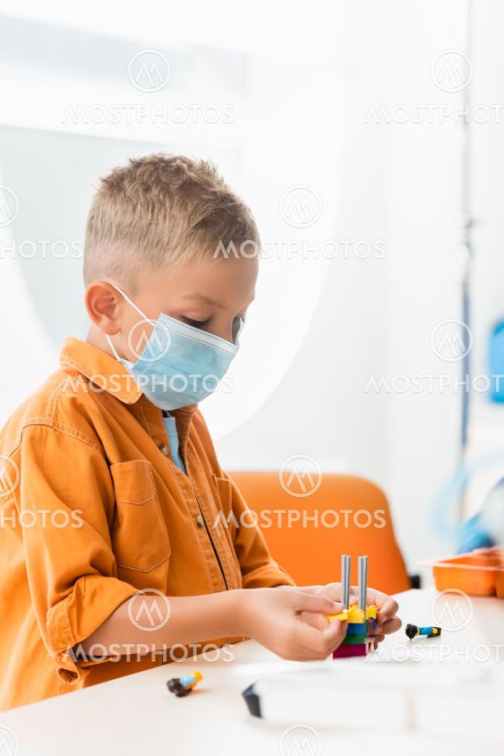 Selective focus of schoolboy in medical mask modeling...