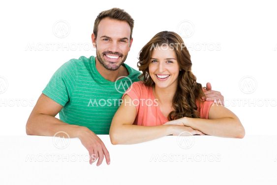 Happy young couple smiling at camera