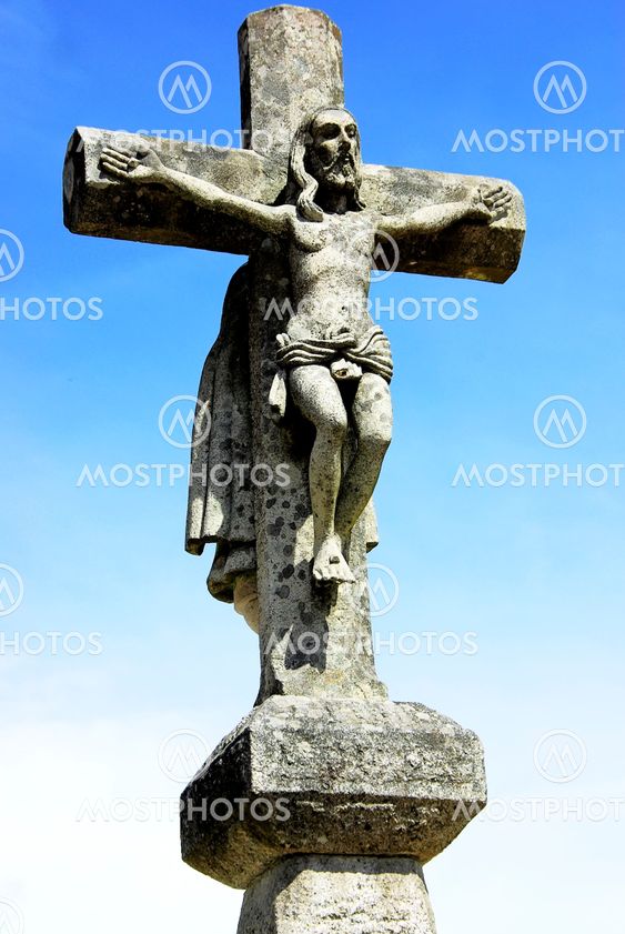 Old cross, and Christ in blue sky.