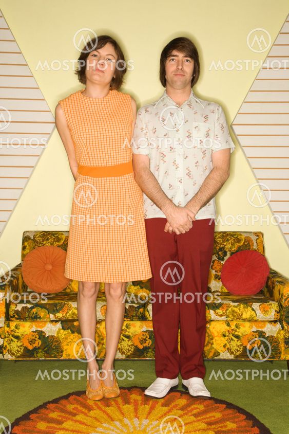 Couple standing in room.