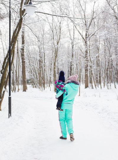 Happy family. Mother and child girl on a winter walk in...